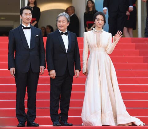 South Korean actor Go Kyung-Pyo, director Park Chan-Wook and actress Tang Wei attend the premiere of Decision To Leave at Palais des Festivals at the 75th Cannes Film Festival, France on Monday, May 23, 2022.  CAN20220523152 RUNExHELLESTAD
