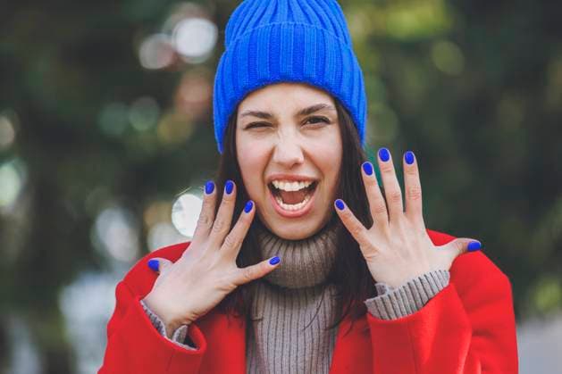 Young woman wearing blue knit hat gesturing with mouth open model released, Symbolfoto, OMIF00787