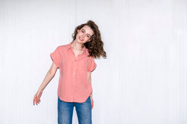 Creative Highlights Symbolbilder Happy beautiful woman standing in front of white wall model released, Symbolfoto property released, VPIF06069