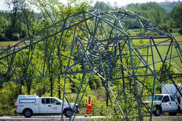 May 24, 2022, Ottawa, ON, CAN: A utility worker looks on at a transmission tower that was damaged in SaturdayöÄÃ s major storm in Ottawa, on Tuesday, May 24, 2022. Ottawa CAN  - ZUMAc35_ 20220524_zaf_c35_020 Copyright: xJustinxTangx