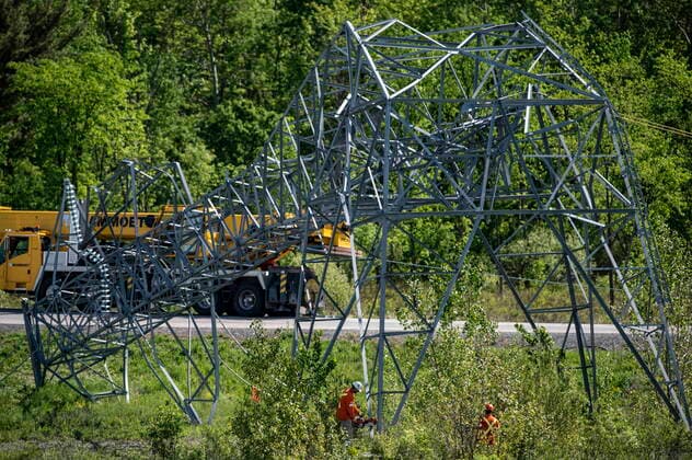 May 24, 2022, Ottawa, ON, CAN: A utility worker uses a cutting tool to sever a transmission tower from its base, after it was damaged in SaturdayöÄÃ s major storm in Ottawa, on Tuesday, May 24, 2022. Ottawa CAN  - ZUMAc35_ 20220524_zaf_c35_022 Copyright: xJustinxTangx