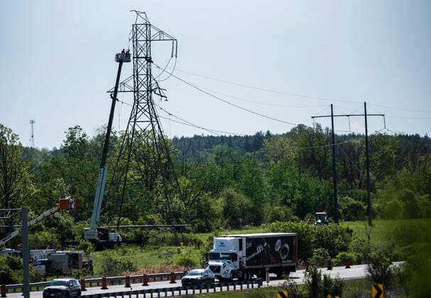 May 24, 2022, Ottawa, ON, CAN: Traffic on Highway 417 passes by as crews in a lift work on a damaged transmission tower, after SaturdayöÄÃ s major storm caused significant damage to the regionöÄÃ s power distribution network, in Ottawa, on Tuesday, May 24, 2022. Ottawa CAN  - ZUMAc35_ 20220524_zaf_c35_030 Copyright: xJustinxTangx