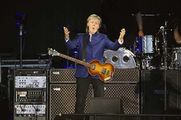 Paul McCartney shrugs as he walks onto the stage to perform with his band at the Camping World Stadium in Orlando, Florida on Saturday, May 28, 2022.  ORP20220528030 JOExMARINO