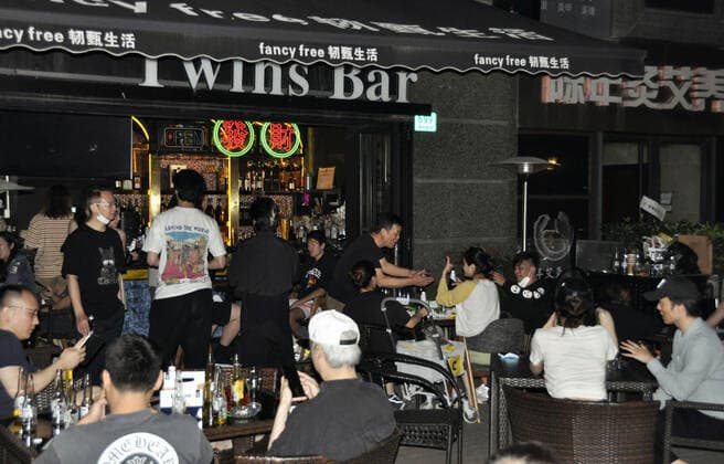 Shanghai lifts 2-month-long lockdown People drink at a bar in Shanghai in the early hours of June 1, 2022, as the Chinese city lifts its two-month-long lockdown, allowing around 90 percent of its residents to leave home and public transport to restart.  A14AA0001295674P