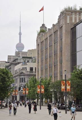 Shanghai lifts 2-month-long lockdown People wearing face masks walk in Shanghai on June 1, 2022, as the Chinese city lifts its two-month-long lockdown, allowing around 90 percent of its residents to leave home and resuming public transport.  A14AA0001295675P