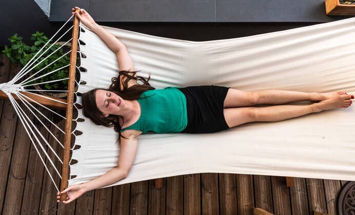 Creative Highlights Symbolbilder Attractive white slim 30 year old lady lying in a hammock in her garden, Laeken, Belgium