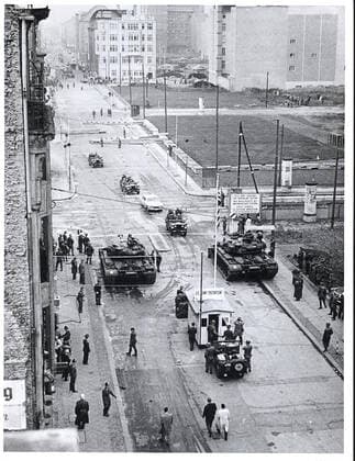 Berlin, October 1961. - Beginning August 23, when the East German police closed all but seven of the crossing points between the two parts of this city and limited access for allied personnel to Friedrich Strasse, the Communists attempted to limit the entry of Americans into the Soviet Sector. This campaign reached a climax in late October, when the People s Police insisted upon identification of persons entering East Berlin in official American cars. The Americans, under instructions from their government, refused to identify themselves. As a demonstration of the right of access to East Berlin the U.S. Army on October 26 escorted an American car past the communist police lines at Friedrich Strasse. The police permitted the car to pass w 1062_05_M_-12870-