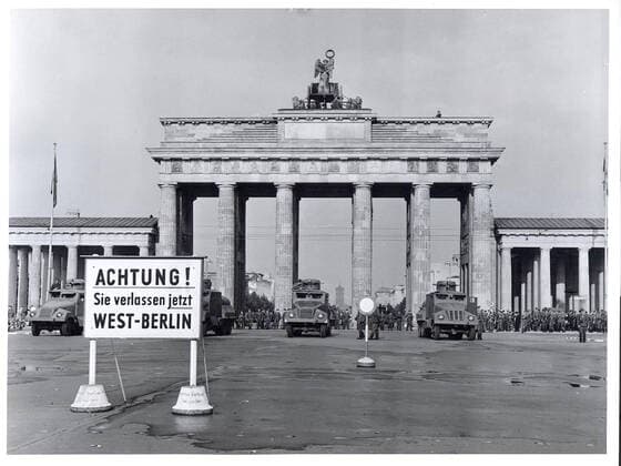 Original caption: East Berlin Put Behind Iron Curtain Berlin, August 1961 - In a final attempt to halt a flood of refugees escaping from East Germany through West Berlin, the Communist Government of the Soviet Zone moved on August 13th to block off East Berlin with troops, road blocks and barbed wire. Heavily armed East German forces, backed up by Soviet army units, patrolled the East Sector to prevent disturbances while the free West Berliners, angered by the Communist action, demonstrated on their side of the border in sympathy with those now cut off from any contact with the West. Military water trucks, with high-pressure hoses mounted in their turrets, are lined up in lead position along the Brandenburg Gate border. Behind are East Be 1062_05_M_-12912-
