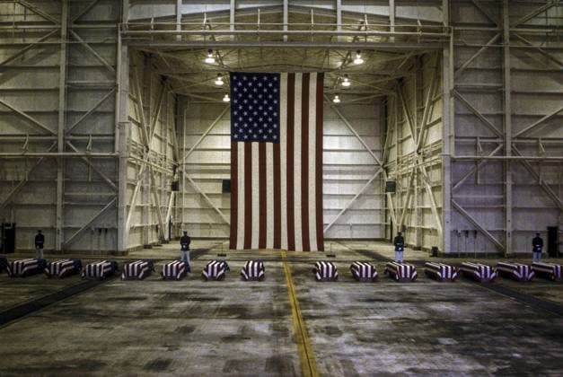 October 29, 1983 - Dover, Delaware, U.S - Dover, Delaware. USA, 29th October, 1983.At precisely 7 A.M., a Marine honor guard and a color guard in ceremonial dress uniforms marched into a huge hangar at the Dover Air Force Base and stood facing 16 coffins. Behind them, suspended from the beams of the hangar, was a 38-foot American flag..The ceremony was the first on American soil honoring servicemen killed in the bombing in Beirut and the invasion of Grenada. Dover U.S. - ZUMAr142 1012556829st Copyright: xMarkxReinsteinx