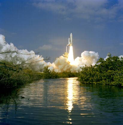 (12 Nov. 1981) --- Framed here by Florida vegetation, the 37-meter-tall (122 feet) NASA space shuttle Columbia lifts off from Launch Pad 39A at NASA-Kennedy Space Center (KSC). Astronauts Joe H. Engle and Richard H. Truly begin the second space shuttle (STS-2) flight. 1062_36_M_-11497-