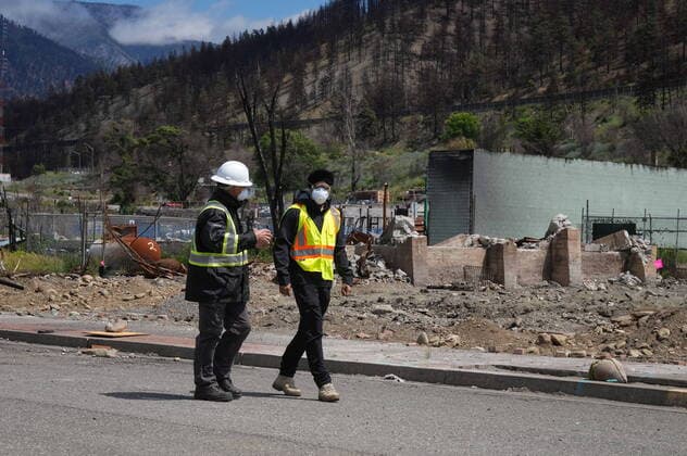 June 14, 2022, LYTTON, BC, CANADA: Harjit Sajjan, right, minister of International Development, views wildfire damage with Owen Collings, a resident who works as site support for the village, in Lytton, B.C., on Tuesday, June 14, 2022. The fire-ravaged community of Lytton, B.C., will get $77 million from the federal government to help it rebuild a fire-resistant and energy-efficient community. Two people were killed and much of the centre of the village was destroyed when wildfire ripped through the community almost a year ago. LYTTON CANADA - ZUMAc35_ 20220614_zaf_c35_069 Copyright: xDarrylxDyckx
