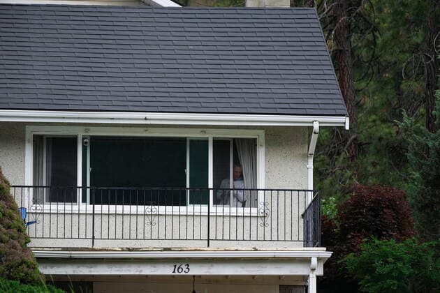 June 14, 2022, LYTTON, BC, CANADA: A resident watches from a house above the Trans-Canada Highway as Harjit Sajjan, minister of International Development, speaks during an announcement about funding to rebuild the village of Lytton, B.C., on Tuesday, June 14, 2022. The fire-ravaged community of Lytton, B.C., will get $77 million from the federal government to help it rebuild a fire-resistant and energy-efficient community. Two people were killed and much of the centre of the village was destroyed when wildfire ripped through the community almost a year ago. LYTTON CANADA - ZUMAc35_ 20220614_zaf_c35_103 Copyright: xDarrylxDyckx