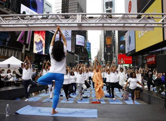 People attend a yoga class at the 20th Anniversary celebration of the Summer Solstice in Times Square: Mind Over Madness Yoga, an annual all-day outdoor yoga event, in New York City on Tuesday, June 21, 2022.  NYP20220621105 JohnxAngelillo