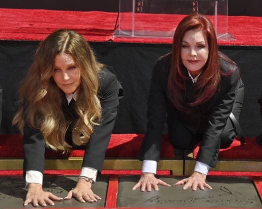 Lisa Marie Presley (L) and Priscilla Presley participate in a handprint ceremony immortalizing the Elvis Presley family members in the forecourt of the TCL Chinese Theatre (formerly Grauman s) in the Hollywood section of Los Angeles on Tuesday, June 21, 2022.  LAP2022062102 JIMxRUYMEN