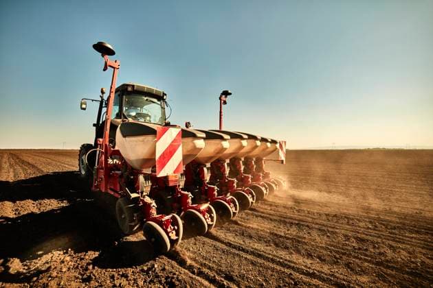 Tractor with seeder machine sowing seed in soybean farm model released, Symbolfoto, NOF00510