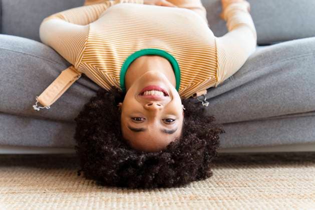 Creative Highlights Symbolbilder Smiling woman lying on sofa at home model released, Symbolfoto property released, OIPF01748