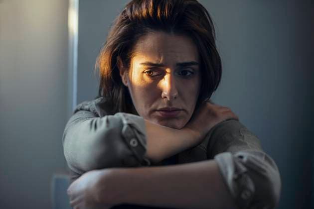Worried woman sitting with sunlight on face at home model released, Symbolfoto property released, JSRF02005