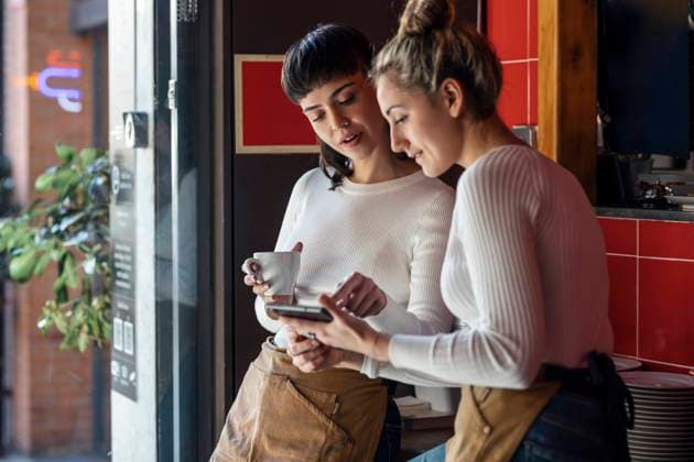 Restaurant owners discussing over tablet PC model released, Symbolfoto property released, JSRF02055