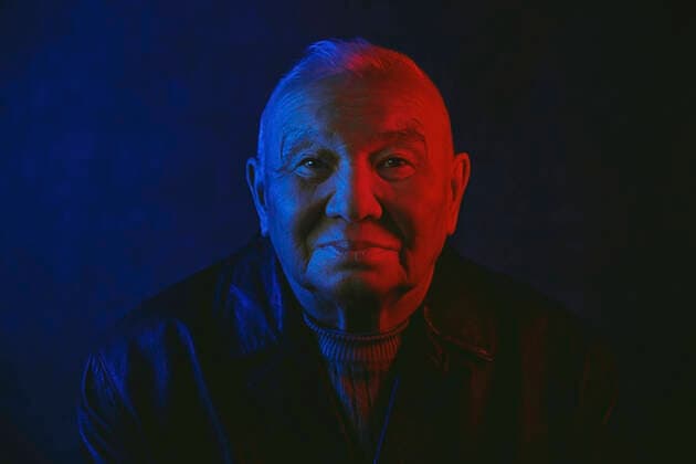 Creative Highlights Symbolbilder Senior man s face illuminated with red and blue neon light against black background model released, Symbolfoto, AZF00411