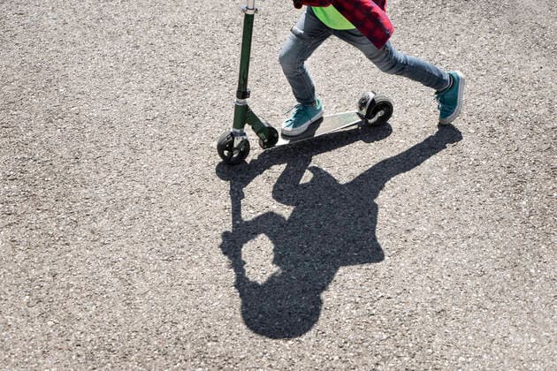 Creative Highlights Symbolbilder Boy riding push scooter on road model released, Symbolfoto property released, RNF01400