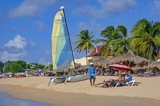 Tourists sunning on sandy beach of Rodney Bay, Gros Islet District on the island of Saint Lucia in the Caribbean Sea Arterrax xMaricaxvanxderxMeer 1012_14_211018p059