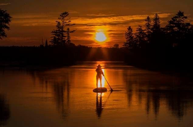 June 26, 2022, KAWARTHA LAKES, ONT, CANADA: A paddle boarder greets the dawn on Pigeon Lake in city of Kawartha Lakes, Ontario on Sunday, June 26, 2022. With the summer solstice having just passed we are still in for some of the longest days of the year until the end of July. KAWARTHA LAKES CANADA  - ZUMAc35_ 20220626_zaf_c35_024 Copyright: xFredxThornhillx