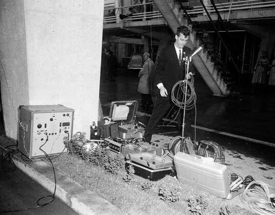 Trip to Europe: Arrival in Vienna, Austria 10:50AM; White House Army Signal Agency (WHASA) staff in Vienna. White House Army Signal Agency (WHASA) staff member, Oscar N. Smith, with communications equipment in preparation for the arrival of President John F. Kennedy at Schwechat Airport in Schwechat, Austria; the President visited Vienna for a summit with Soviet Union Premier Nikita Khrushchev. Copyright: xpiemagsx