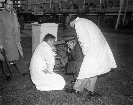 Trip to Europe: Arrival in Vienna, Austria 10:50AM; White House Army Signal Agency (WHASA) staff in Vienna. Four unidentified men (two kneeling, two standing) use White House Army Signal Agency (WHASA) communications equipment for the arrival of President John F. Kennedy at Schwechat Airport in Schwechat, Austria; the President visited Vienna for a summit with Soviet Union Premier Nikita Khrushchev. Copyright: xpiemagsx