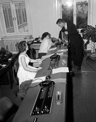 Trip to Europe: Arrival in Vienna, Austria 10:50AM; White House Army Signal Agency (WHASA) staff in Vienna. White House Army Signal Agency (WHASA) staff prepare communications equipment for a summit between President John F. Kennedy and Soviet Union Premier Nikita Khrushchev in Vienna, Austria. WHASA officer Oscar N. Smith stands at right. Copyright: xpiemagsx