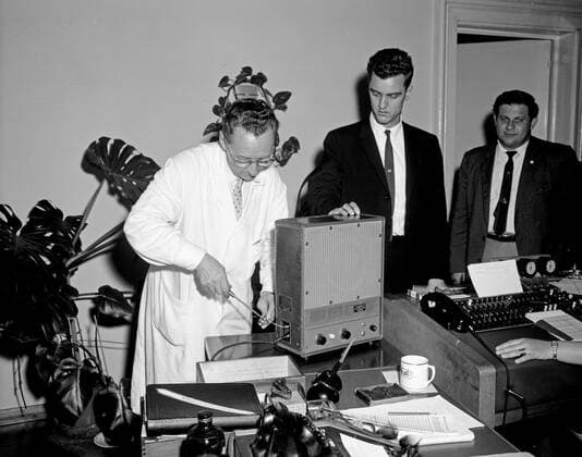 Trip to Europe: Arrival in Vienna, Austria 10:50AM; White House Army Signal Agency (WHASA) staff in Vienna. White House Army Signal Agency (WHASA) staff prepare communications equipment for a summit between President John F. Kennedy and Soviet Union Premier Nikita Khrushchev in Vienna, Austria. WHASA officer Oscar N. Smith stands second from right; others are unidentified. Copyright: xpiemagsx
