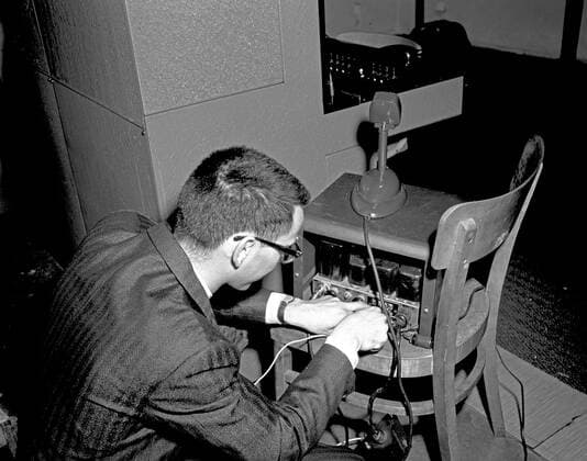 Trip to Europe: Arrival in Vienna, Austria 10:50AM; White House Army Signal Agency (WHASA) staff in Vienna. An unidentified man works on White House Army Signal Agency (WHASA) equipment in preparation for a summit between President John F. Kennedy and Soviet Union Premier Nikita Khrushchev in Vienna, Austria. Copyright: xpiemagsx