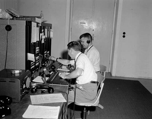 Trip to Europe: Arrival in Vienna, Austria 10:50AM; White House Army Signal Agency (WHASA) staff in Vienna. Two unidentified White House Army Signal Agency (WHASA) staff members use communications equipment in preparation for a summit between President John F. Kennedy and Soviet Union Premier Nikita Khrushchev in Vienna, Austria. Copyright: xpiemagsx