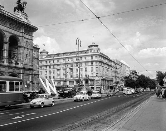 Trip to Europe: Arrival in Vienna, Austria 10:50AM; White House Army Signal Agency (WHASA) staff in Vienna. The Hotel Bristol in Vienna, Austria, where White House Army Signal Agency (WHASA) staff members stayed prior to and during the summit between President John F. Kennedy and Soviet Union Premier Nikita Khrushchev. The building on the left is the Vienna State Opera (Wiener Staatsoper). Copyright: xpiemagsx