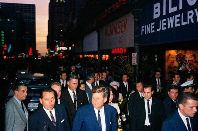 Trip to Texas: Houston: League of United Latin American Citizens (LULAC) Dinner, Rice Hotel. President John F. Kennedy and First Lady Jacqueline Kennedy (partially hidden) arrive at the Rice Hotel in Houston, Texas. Walking behind: Vice President Lyndon B. Johnson; Lady Bird Johnson; Governor of Texas, John B. Connally, Jr.; Nellie Connally. Also pictured: Dean of the White House press corps and United Press International (UPI) reporter, Merriman Smitty Smith; White House Secret Service agents, Clint Hill, Jack Ready, Roy Kellerman, Rufus Youngblood, Ernie Olsson, Dick Johnsen, and Ron Pontius. Copyright: xpiemagsx