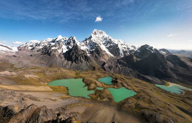 Creative Highlights World Breathtaking view of tranquil lakes with turquoise water located on slope of Ausangate mountain near snowy peaks against cloudy blue sky in Peru TheTrioStudio_AusangateMountainPeru_00002.jpg Copyright: xThexTrioxStudiox Model Released