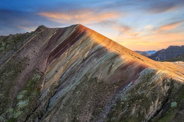 Creative Highlights World Breathtaking scenery of massive mountain range of Palccoyo with colorful grassy slopes against scenic sunset sky in Peru TheTrioStudio_PalccoyoMountainPeru_00002.jpg Copyright: xThexTrioxStudiox Model Released