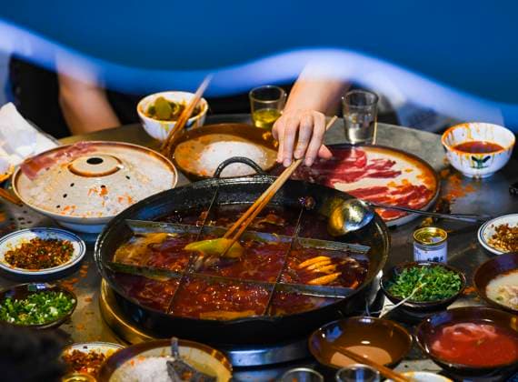 (220703) -- CHONGQING, July 3, 2022 -- People enjoy a meal at a hot pot restaurant at a commercial street in southwest China s Chongqing Municipality, June 5, 2022. Under COVID-19 prevention and control measures, Chongqing in southwest China has striven to combine its night economy with culture and tourism in innovative ways, thus enhancing the vitality and attraction of nighttime consumption and turbocharging its development. ) CHINA-CHONGQING-NIGHT ECONOMY (CN) WangxQuanchao 