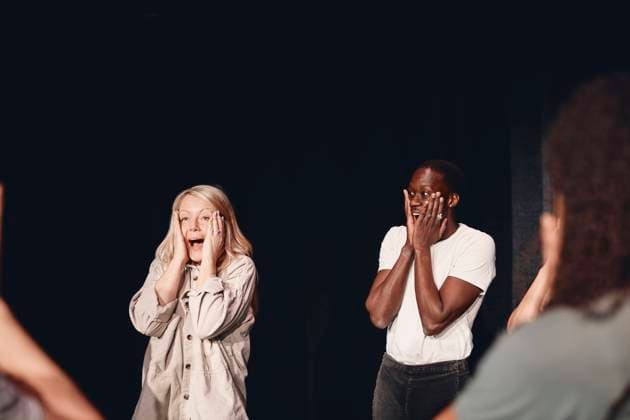 Multiracial male and female stage performers with heads in hands practicing emotions together in class Sweden, Stockholm, model released, property released Copyright: xMaskotx , MA93140 MA93140