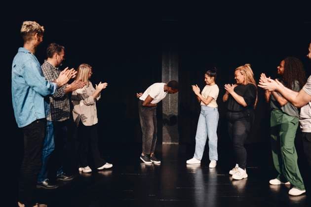 Multiracial male and female artists applauding for actor bowing on stage Sweden, Stockholm, model released, property released Copyright: xMaskotx , MA93151 MA93151