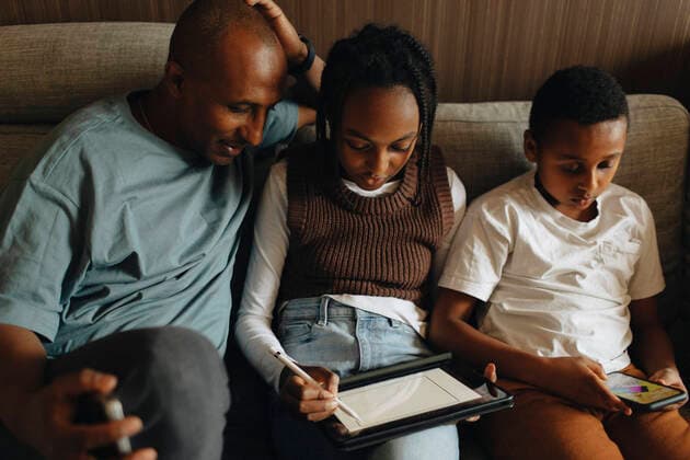 Father sitting with daughter and son using wireless technologies at home Sweden, Stockholm, model released, property released Copyright: xMaskotx , MA93613 MA93613