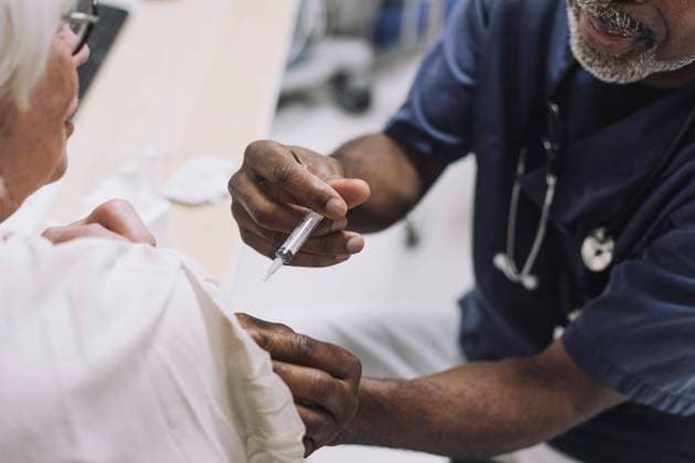 Male doctor injecting senior female patient in medical clinic Sweden, Stockholm, model released, property released Copyright: xMaskotx , MA94560 MA94560