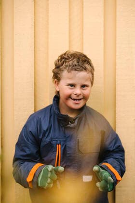 Creative Highlights Symbolbilder Portrait of happy boy with down syndrome gesturing against wall Sweden, Gothenburg, model released Copyright: xMaskotx , MA93791 MA93791