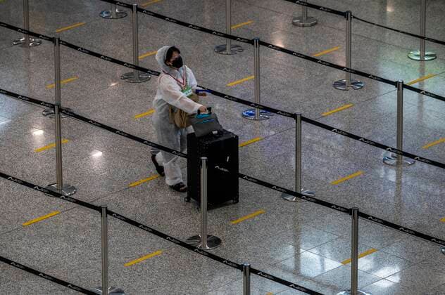 Coronavirus in China, Reisende am Flughafen in Hongkong Hong Kong Suspends Covid-19 Flight Bans A women wear a PPE pushing a luggage inside Hong Kong International Airport on July 7, 2022 in Hong Kong, China. The Hong Kong Government announce that it will suspend the Covid-19 flight ban mechanism which ban flights carrying more than 5 Covid-19 positive passengers to fly to the city for five days. Hong Kong Hong Kong  Copyright: xVernonxYuenx originalFilename: yuen-hongkong220707_npP68.jpg