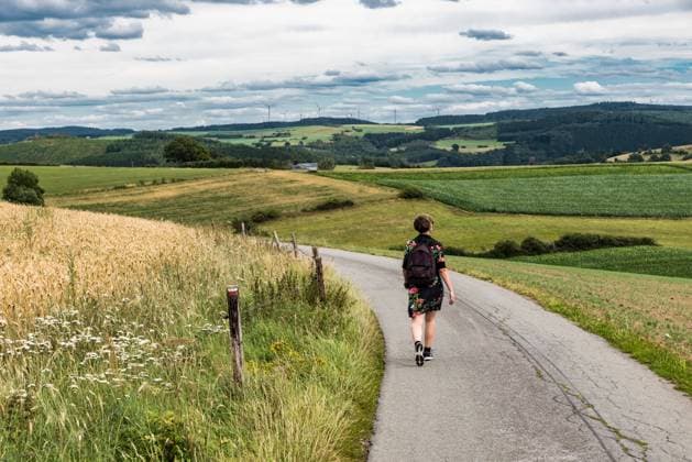 Active woman walking through the fields at the countryside, Belgium