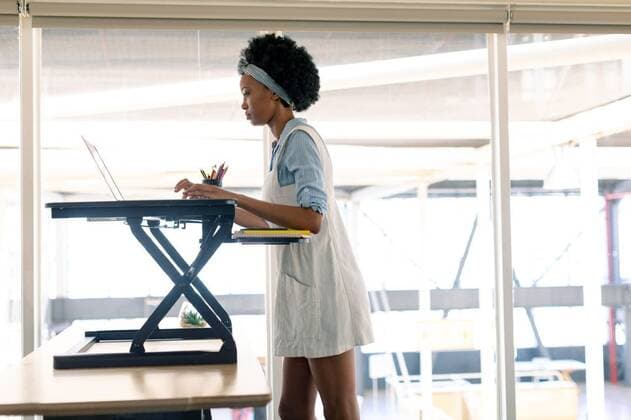 Female graphic designer working on laptop at desk Side view of African american female graphic designer working on laptop at desk in office, model released, , property released, Cape Town, South Africa, 16.03.2019, 1260585.jpg, millennial, beautiful, smart casual, headband, curly hair, business, businesswoman, graphic designer, designer, artist, executive, associate, occupation, profession, professional, skill, expertise, entrepreneur, corporate, company, office, workplace, desk, computer stand, penholder, standing, working, looking, using laptop, laptop, notebook, computer, electronic, wireless technology, communication, global communication, connection, focused, modern, leisure, lifestyle, african american ethnicity Young Adult,Woman,Fem