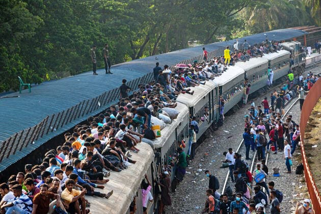July 9, 2022, Dhaka, Dhaka, Bangladesh: Failed to get place inside the train, Bangladeshi holidaymakers ride on overcrowded train and risk their lives as they rush home to be with their families ahead of the biggest Muslim festival, Eid al-Adha, feast of sacrifice, at the Airport Railway Station in Dhaka, Bangladesh. Thousands of Dhaka city dwellers started leaving the city for their hometown in a desperate attempt to celebrate Eid al-adha festival. Locals tackle the journey climbing on, clinging to and clambering along the roofs of locomotives. Men, women and children climb and are pulled up onto the roof of the train as they try to find themselves a space. With no seats available inside, many commuters decide to take the risk and choose a - ZUMAs231 20220709_zip_s231_029 Copyright: xJoyxSahax