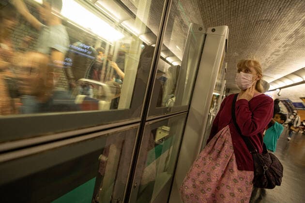 (220709) -- PARIS, July 9, 2022 -- A woman wearing a face mask waits at a subway station in Paris, France, July 8, 2022. The total number of COVID-19 related deaths in France passed the 150,000 mark on Friday, after 74 deaths related to the virus were recorded in hospitals in the past 24 hours, announced the country s public health agency. (Photo by Xinhua) FRANCE-PARIS-COVID-19-DEATH AurelienxMorissard 
