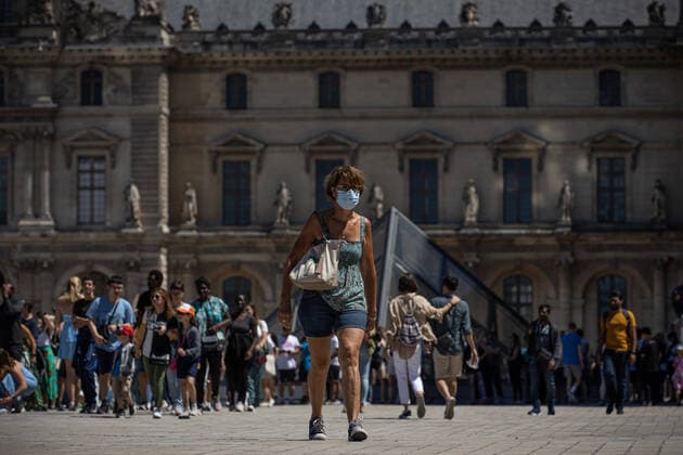 (220709) -- PARIS, July 9, 2022 -- A woman wearing a face mask walks in front of the Louvre Museum in Paris, France, July 8, 2022. The total number of COVID-19 related deaths in France passed the 150,000 mark on Friday, after 74 deaths related to the virus were recorded in hospitals in the past 24 hours, announced the country s public health agency. (Photo by Xinhua) FRANCE-PARIS-COVID-19-DEATH AurelienxMorissard 