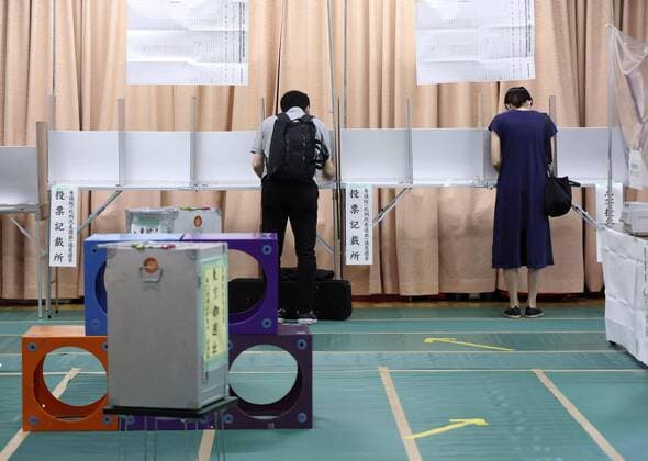 Japan s upper house election Voters fill out their ballots for Japan s House of Councillors election at a polling station in Tokyo on July 10, 2022.  A14AA0001312777P