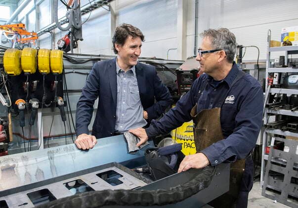 July 12, 2022, Sherbrooke, PQ, Canada: Prime Minister Justin Trudeau talks with a worker during a tour of Motrec, a heavy-duty electric vehicle production facility in Sherbrooke, Que., Tuesday, July 12, 2022. Sherbrooke Canada  - ZUMAc35_ 20220712_zaf_c35_023 Copyright: xGrahamxHughesx